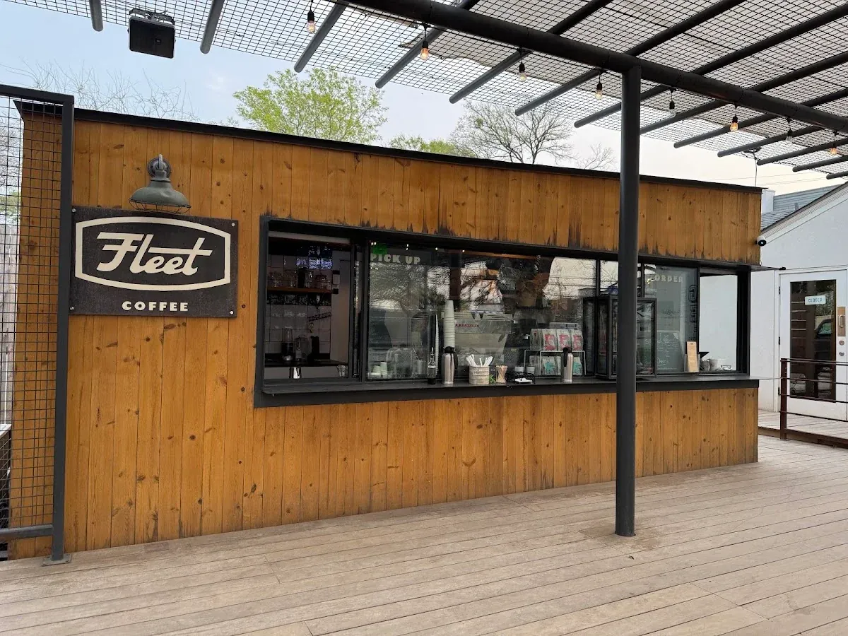 The Fleet Coffee trailer on Manor Road, a wooden cabin with a Fleet sign under a shade structure
