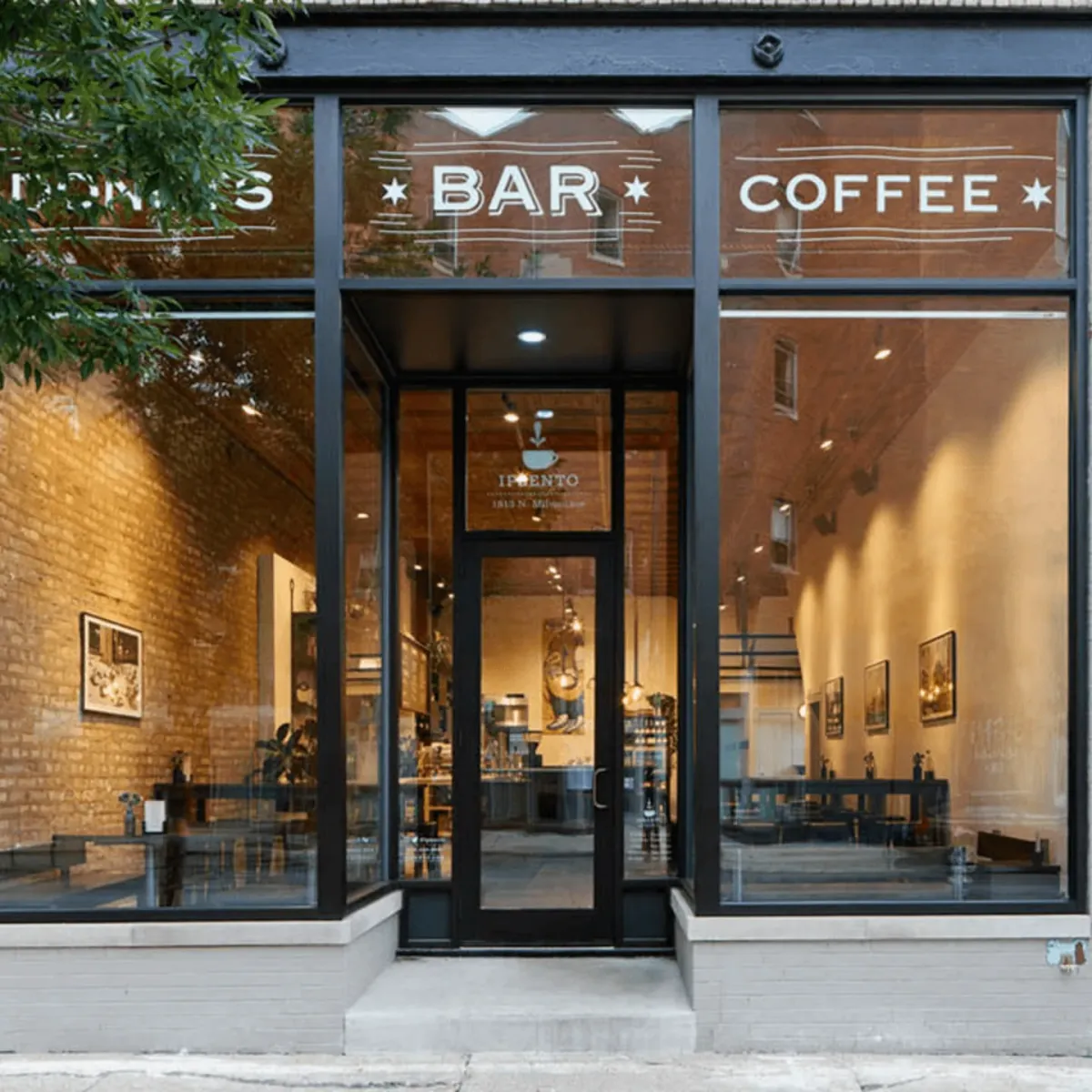 The glass front of Ipsento 606 in Bucktown, lettered Bar and Coffee above the black-framed door, with brick walls inside