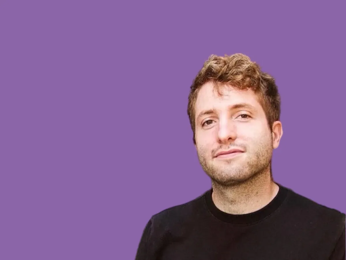 Dayglow founder Tohm Ifergan in a black jumper against a purple background