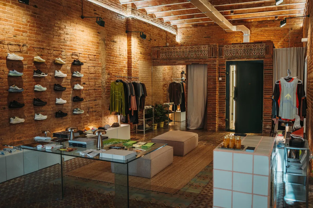 The brick-walled shop floor at Stamina Running, with a wall of running shoes, clothing rails and a tiled counter