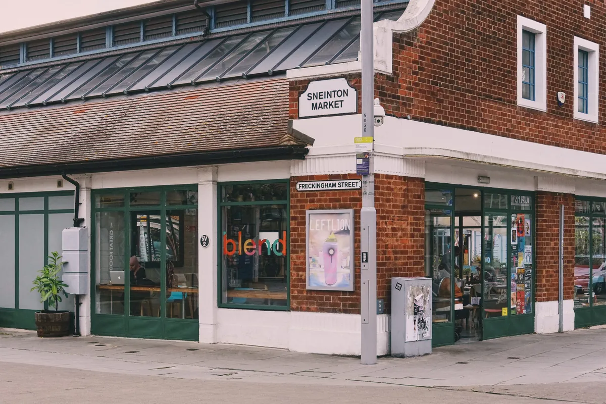 The red-brick corner front of Blend in Sneinton Market, with green window frames and the blend name in the window