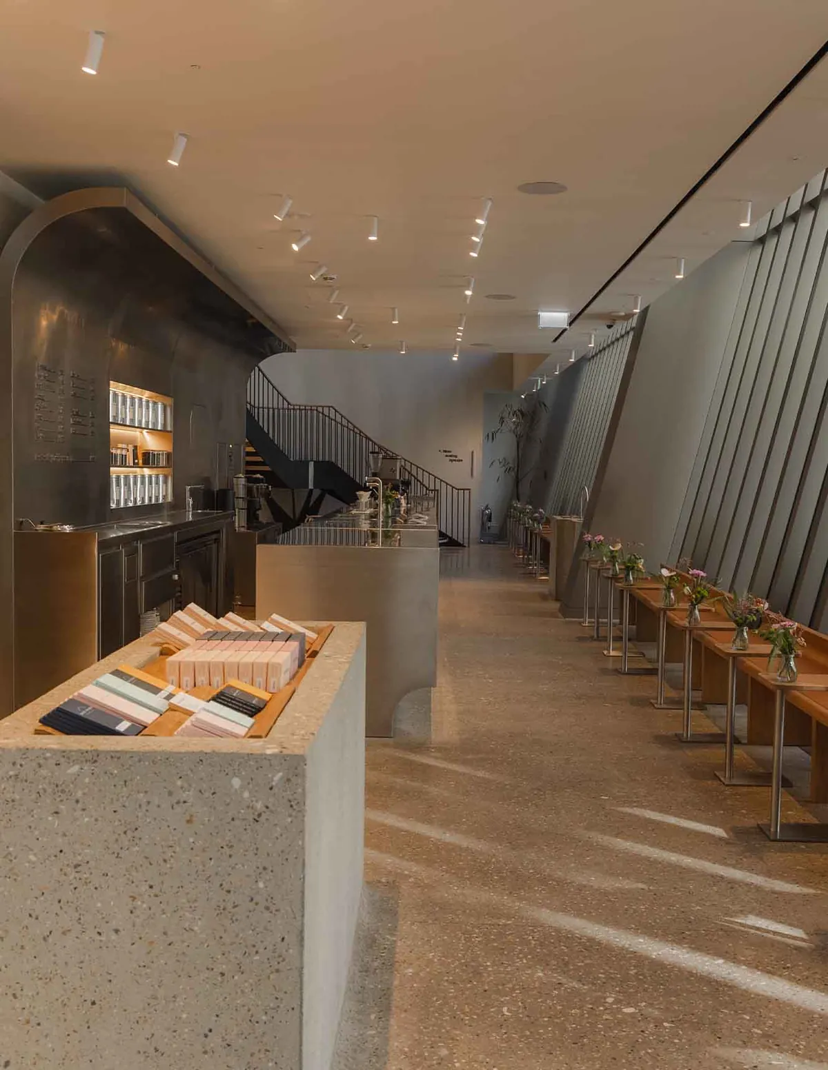 The arched stainless steel bar, terrazzo retail plinth and window counter inside WatchHouse St Mary Axe