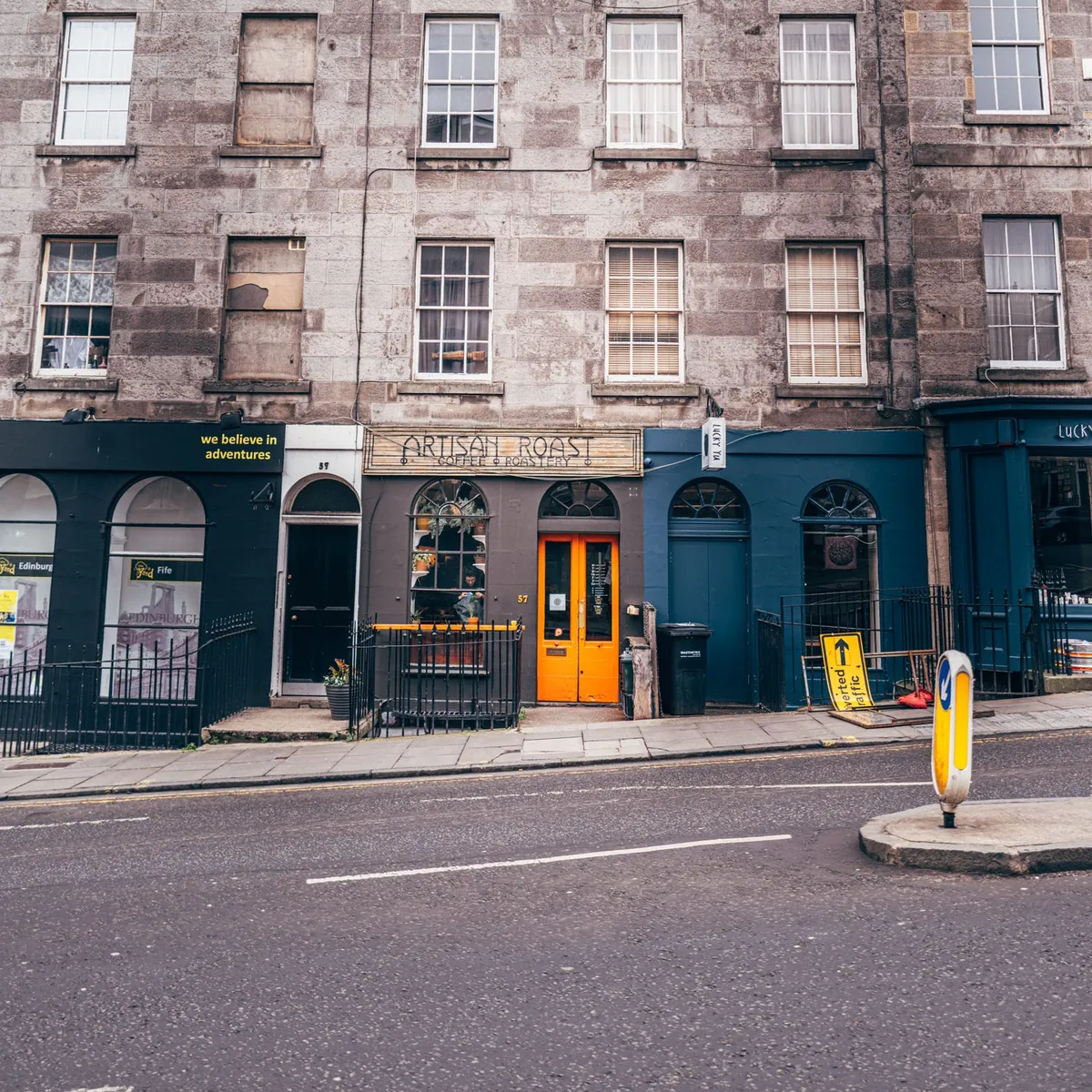 The dark-blue Artisan Roast shopfront with an orange door