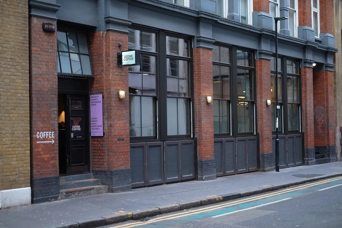 The Ozone Coffee eatery in Shoreditch, with large black-framed windows in a red-brick building