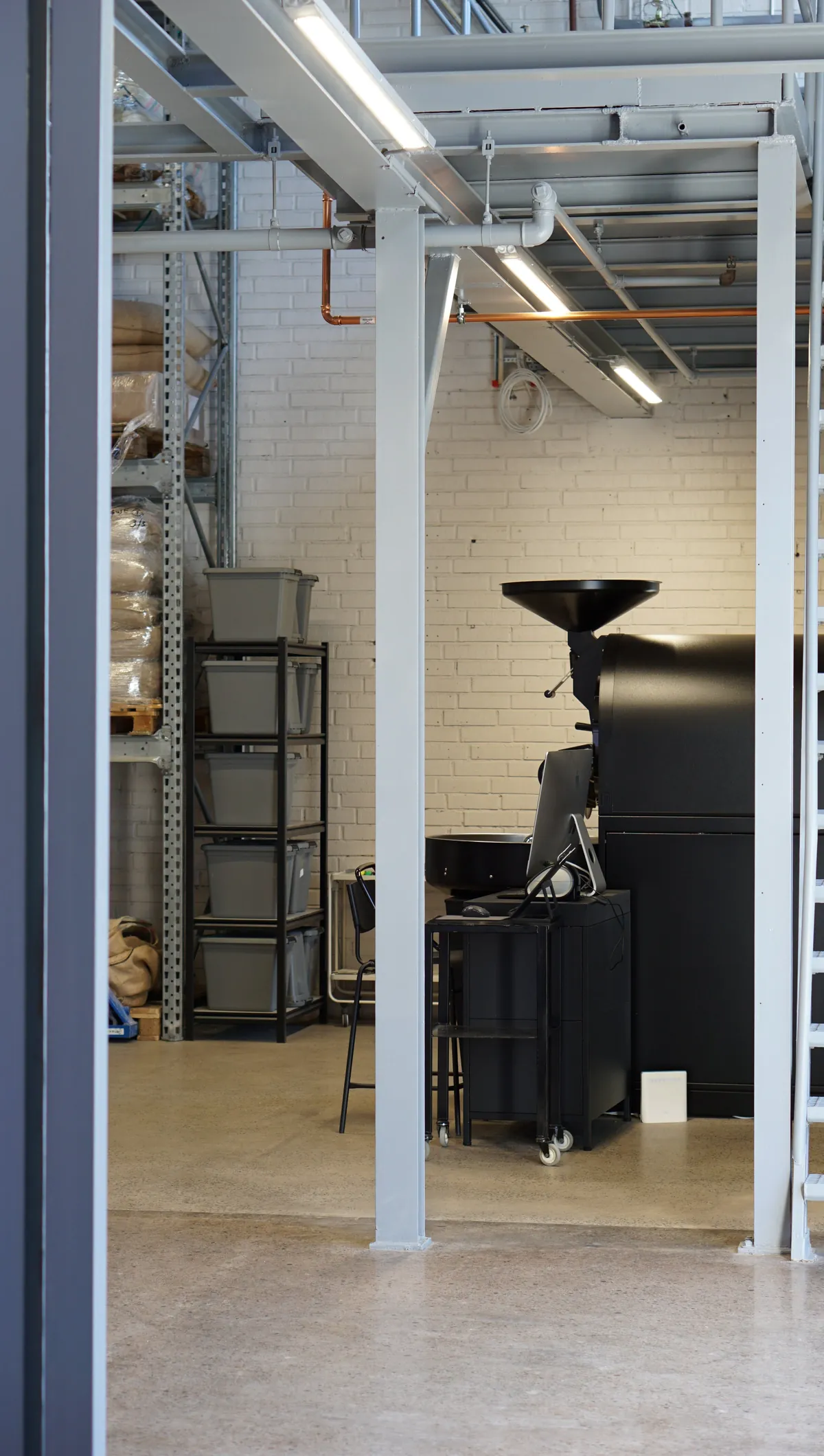 The Probat roaster inside the Swerl roastery, framed by a white steel structure