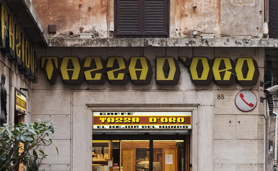 The exterior of Tazza d’Oro, with its gold lettering above the entrance