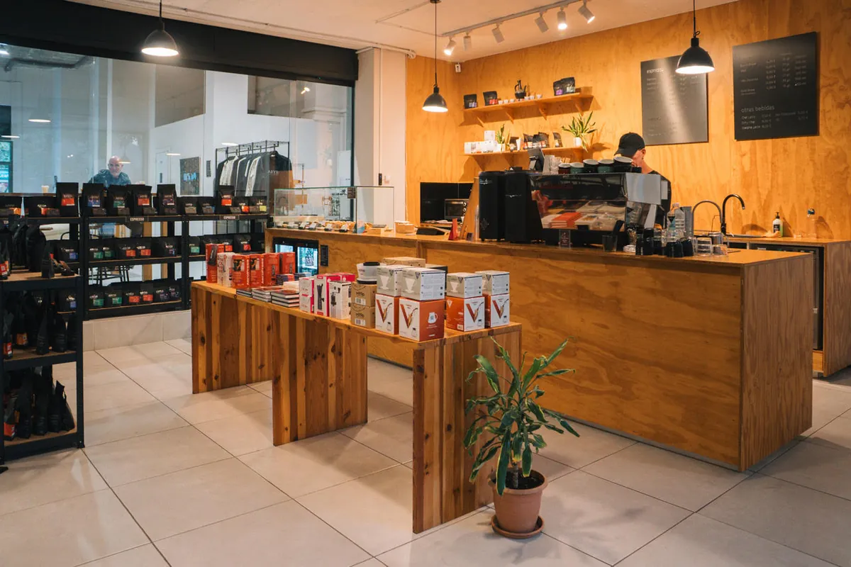 The wooden coffee bar at Abyss Coffee Roasters, with an espresso machine behind the counter and shelves of coffee bags to one side