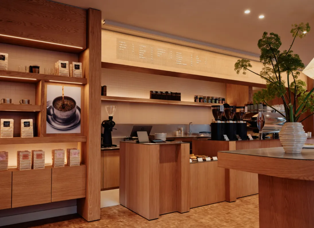 The oak counter and retail shelves inside the Allpress Espresso café in Farringdon
